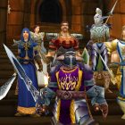 A group of characters in colorful armor stands on a stone staircase in a scene from the game 'World of Warcraft'.